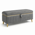 Banc de rangement en velours gris avec pieds en métal doré